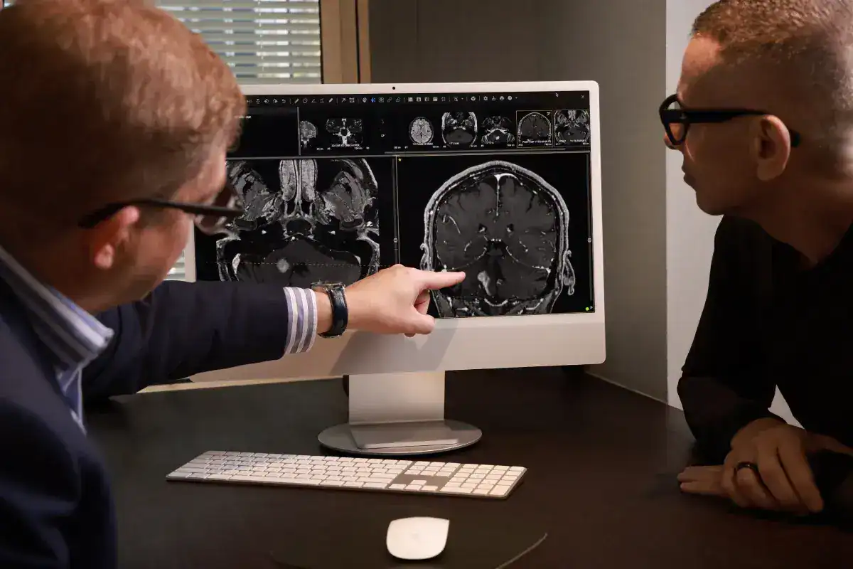Medical professionals reviewing brain MRI scans for tumour diagnosis.