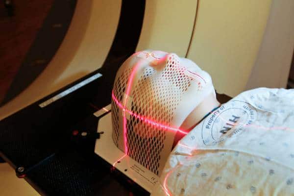 Patient undergoing laser therapy for trigeminal neuralgia pain relief.